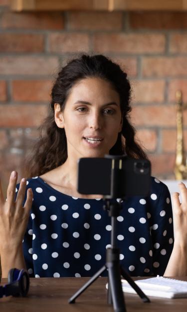 Female teaching online in front of a smartphone