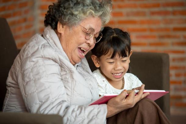 older woman and young girl reading